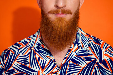 Cropped photo of confident positive guy dressed print shirt having long red beard isolated orange color background