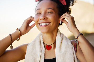 Smile, earphones and black woman with music after workout, training or exercise for wellness, peace or health outdoor. Steaming, radio or gen z girl with motivation, happiness and mindset for fitness