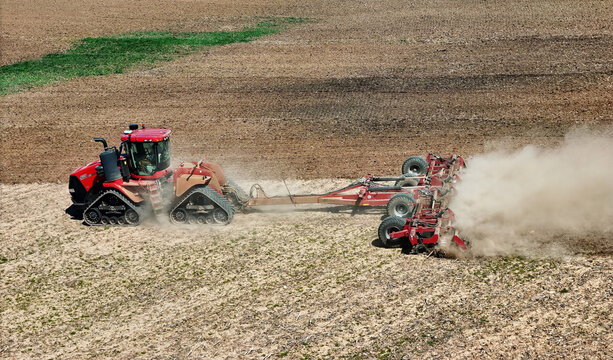 Avon, WI - USA -  April 15, 2024.Case 620 Quadtrac tractor pulling a .Kwik-Till HSD 4000 disk crumbler