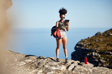 Mountain, hiking and backpack of woman with tablet for travel guide, networking or fitness blog...