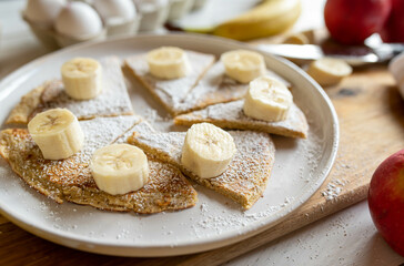 Fototapeta na wymiar Oatmeal pancake with fresh bananas for healthy breakfast on a plate