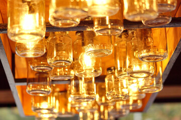 Vintage glass jars on the ceiling in the store in the evening. Light through the glass of the jar.    - 789342639