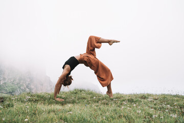 Yoga on nature. Young woman is practicing yoga in mountains - 789344805