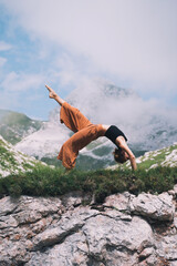 Yoga on nature. Young woman is practicing yoga in mountains - 789344894