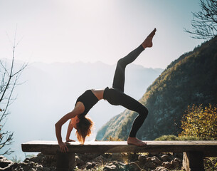Yoga on nature. Young woman is practicing yoga in mountains - 789345009