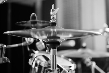 Black and white a drum kit. Night show in a musical instrument recording studio. The drummer knocks...