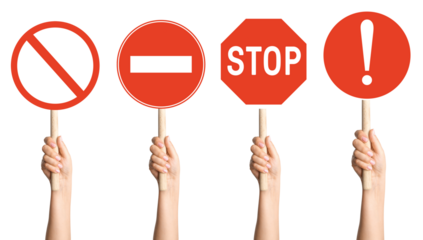 hands holding a set of prohibition signs on a stick on a blank background