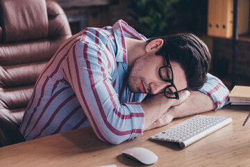 Portrait of young man office worker fell asleep desktop wear shirt loft interior business center...