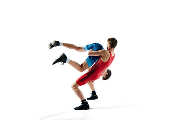 Fototapeta na wymiar Young men, wrestlers showing athleticism and determination as they grapple isolated on white background. Concept of combat sport, martial arts, competition, tournament, dynamics