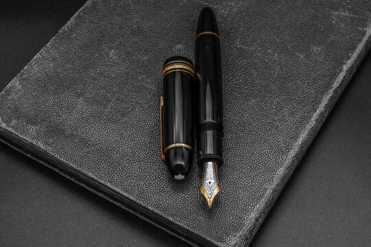 Montblanc Meisterst&uuml;ck 149 fountain pen on an old book. Grey background