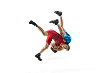 Young male wrestlers demonstrate strength as they engage in competitive bout isolated on white...
