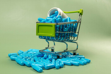 blue medicine capsule in miniature shopping cart
