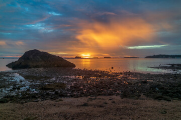 Tranquil view of sunset at beach with rocks
