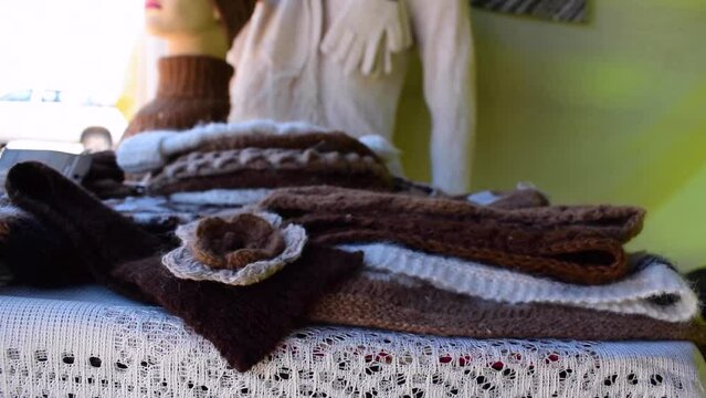 Handmade alpaca crafts on the market in the Andes of Peru and Bolivia. the Andes mountain range illuminated with natural light
