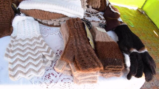Handmade alpaca crafts on the market in the Andes of Peru and Bolivia. the Andes mountain range illuminated with natural light