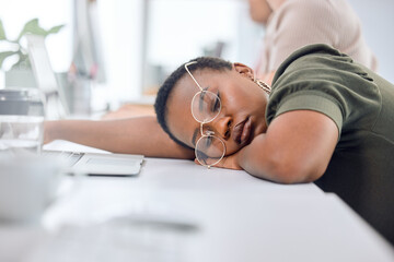 Black woman, sleep and tired in office on table with glasses, exhausted and overtime or deadline....