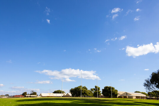 Mostly sky above sporting ground with Australian rules football goalposts,