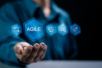 Agile development methodology concept, businessman holding agile icon on virtual screen for process that will help you work faster By reducing step-by-step work and focusing on team. - obrazy, fototapety, plakaty