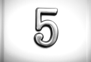 Black & white steel plaque with number FIVE object backdrop