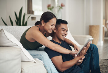 Couple, house and happy with tablet for search on sofa with pointing for decision for buying....