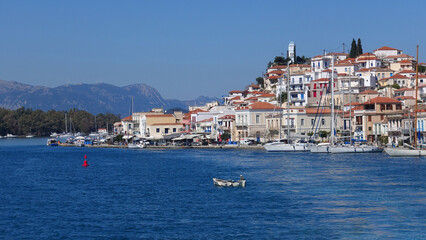 Fototapeta na wymiar Famous main picturesque village of Poros island featuring clock tower, Saronic Gulf, Greece