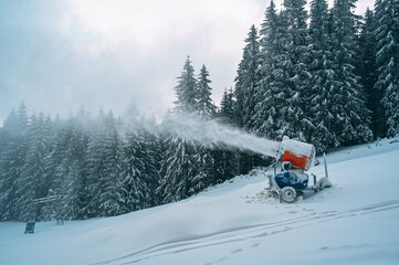 Snow cannon in winter mountains.
