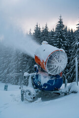 Snow cannon in winter mountains.