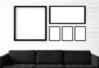 5 blank black picture frames hanging in a white living room