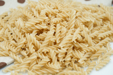 Close up of raw macaroni pasta isolated on white background.