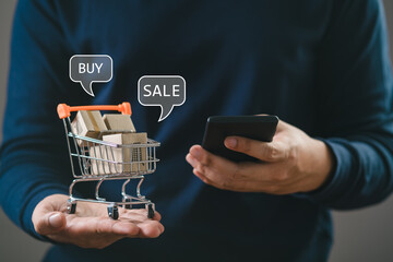man hand using mobile smartphone to buy or sale in shopping online app and the shopping cart with...