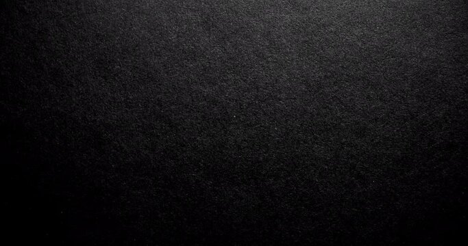 Black rough paper surface, slow moving. Use for background and texture.