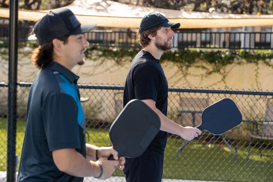 Pickleball players working together as a team. The fun and popular sport is a great way to exercise outside and work together as partners in the competition.