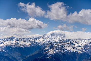 Fototapeta na wymiar Rosa peak looms out of stau clouds, Italy