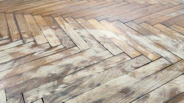 Old parquet background, texture. Old parquet before restoration in an apartment room. Wooden floor background. Old wooden floor in a house.