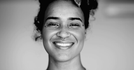 Happy Black Latina of African Descent Smiling at Camera with Friendly Expression in black and white...
