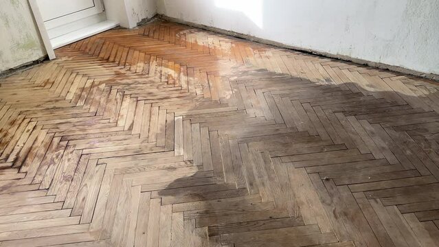 Old parquet background, texture. Old parquet before restoration in an apartment room. Wooden floor background. Old wooden floor in a house.