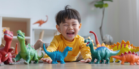 happy child playing with dinosaur toys on the floor