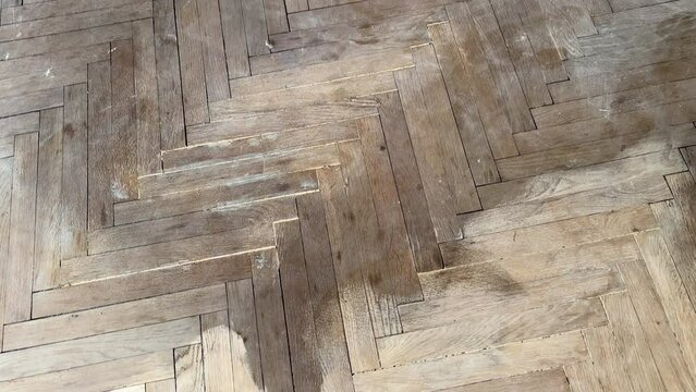 Old parquet background, texture. Old parquet before restoration in an apartment room. Wooden floor background. Old wooden floor in a house.