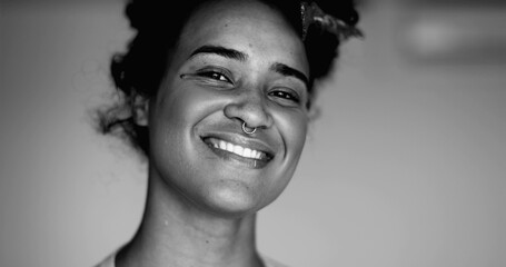 Monochromatic Portrait of a Happy Young Black Brazilian Woman Smiling with Friendly Demeanor,...