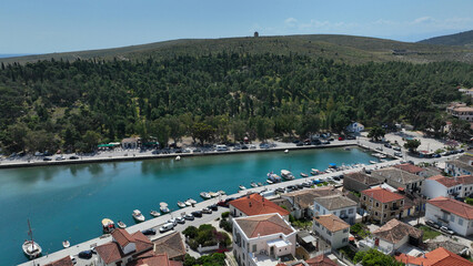 Aerial drone photo of picturesque fishing village of Galaxidi and landmark church of Agios...