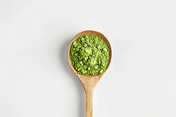 matcha powder on wooden spoon isolated on white background