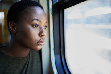Woman, sad and thinking by window in train for bad memory, depression or lonely on public...