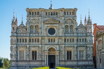 Front view of Certosa di Pavia monastery close up,historical monumental complex that includes a monastery and a sanctuary.The Ducale Palace on the right,Pavia,Italy. - obrazy, fototapety, plakaty