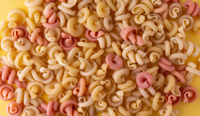 Yellow and pink Pasta insalatonde close-up. Top view. Flatlay. Texture