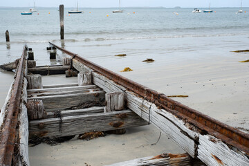 Abandoned wooden slipway with rusted iron glides on the beach by which ships or boats can be moved...