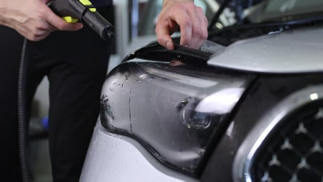 Gluing PPF film on the car with the steam for protection of the car surface against mechanical abrasion, UV, IV and road contamination