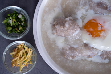 Hot Thai congee (rice porridge) with minced pork ball and boiled egg as breakfast.