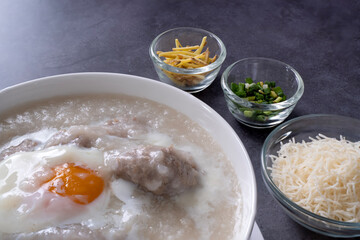 Hot Thai congee (rice porridge) with minced pork ball and boiled egg as breakfast.
