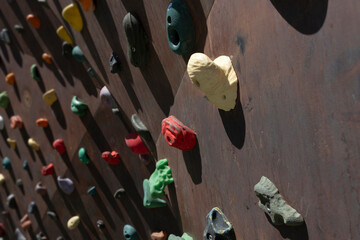 Climbing Wall outdoors. Artificially constructed wall with manufactured handles (or 'grips') for the hands and feet attached to a corten steel background