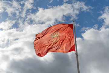 Navarra flag in the wind with blue background and clouds